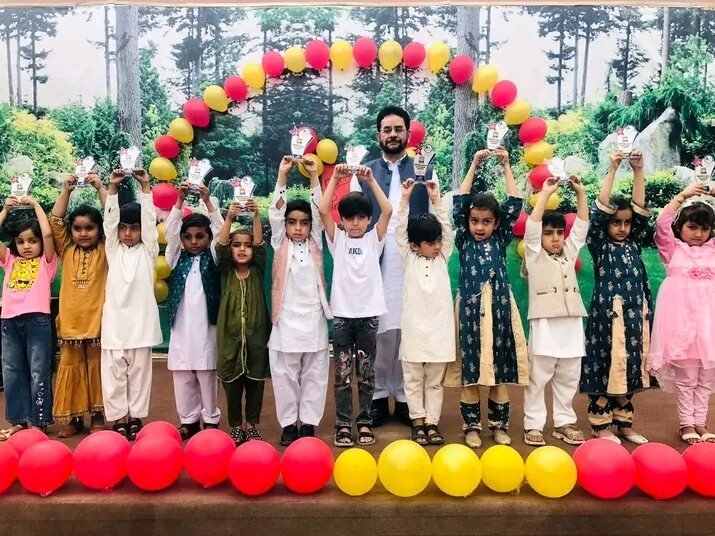 Edutop students holding trophies on stage at a prize distribution ceremony